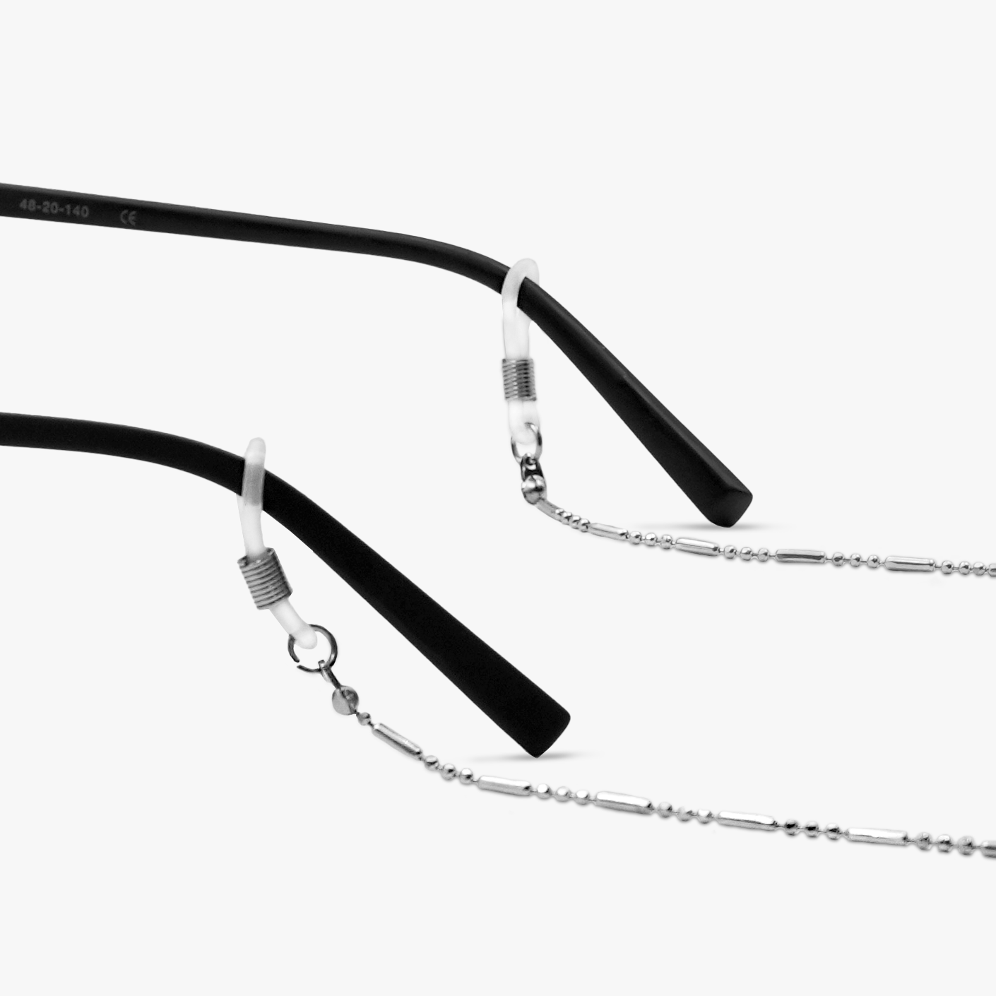 Silver cord attached to black eyeglass temples
