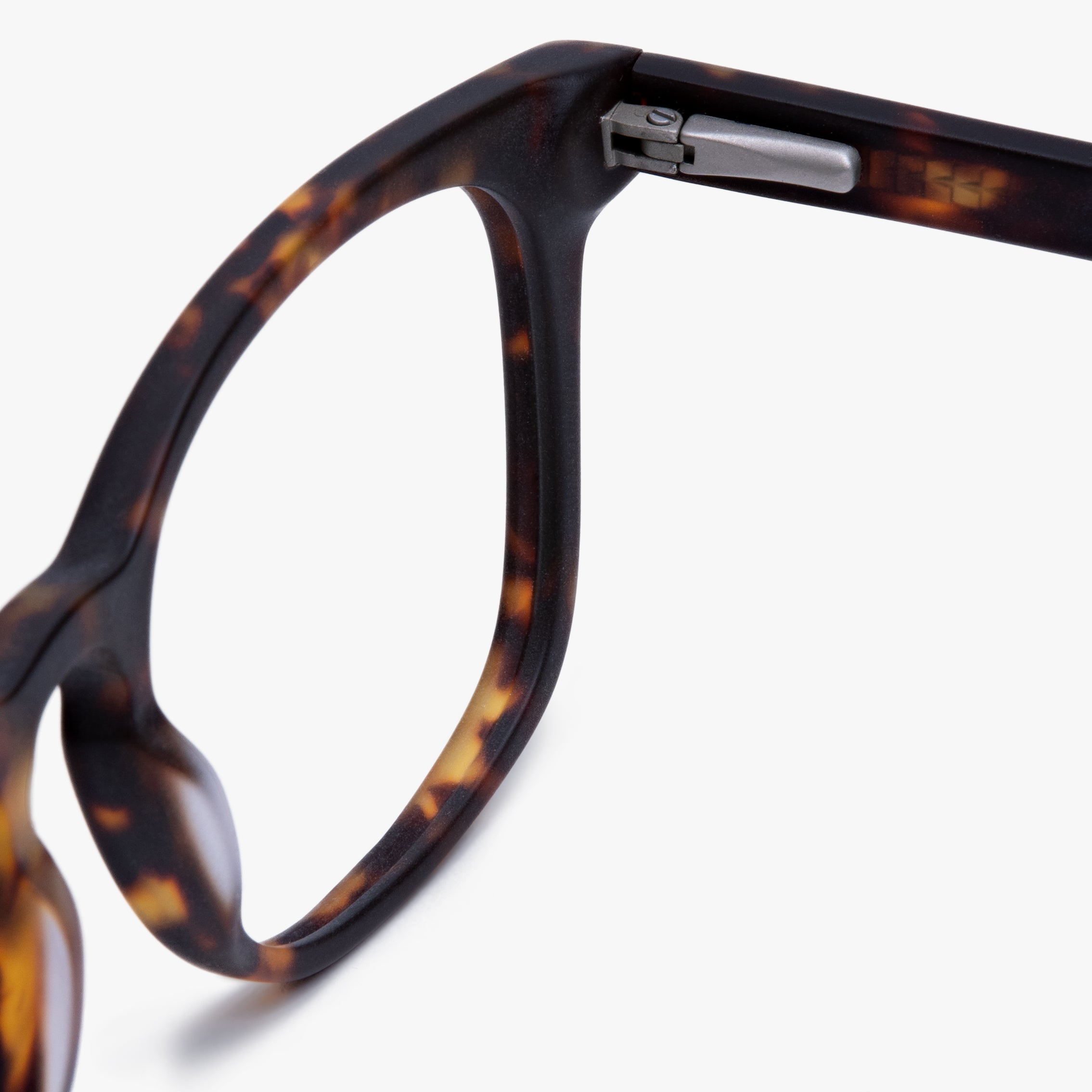 Close-up of dark turtle eyeglasses frame hinge with tortoiseshell pattern
