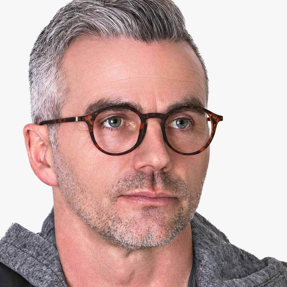 Person wearing tortoiseshell reading glasses