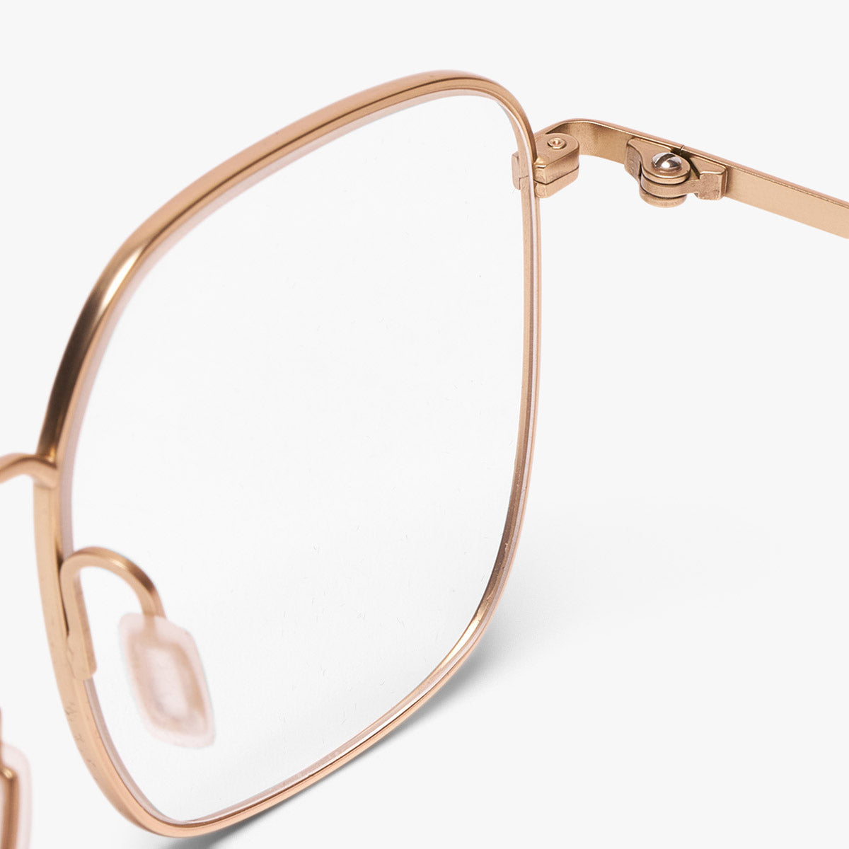 Close-up of gold square-frame glasses with nose pads