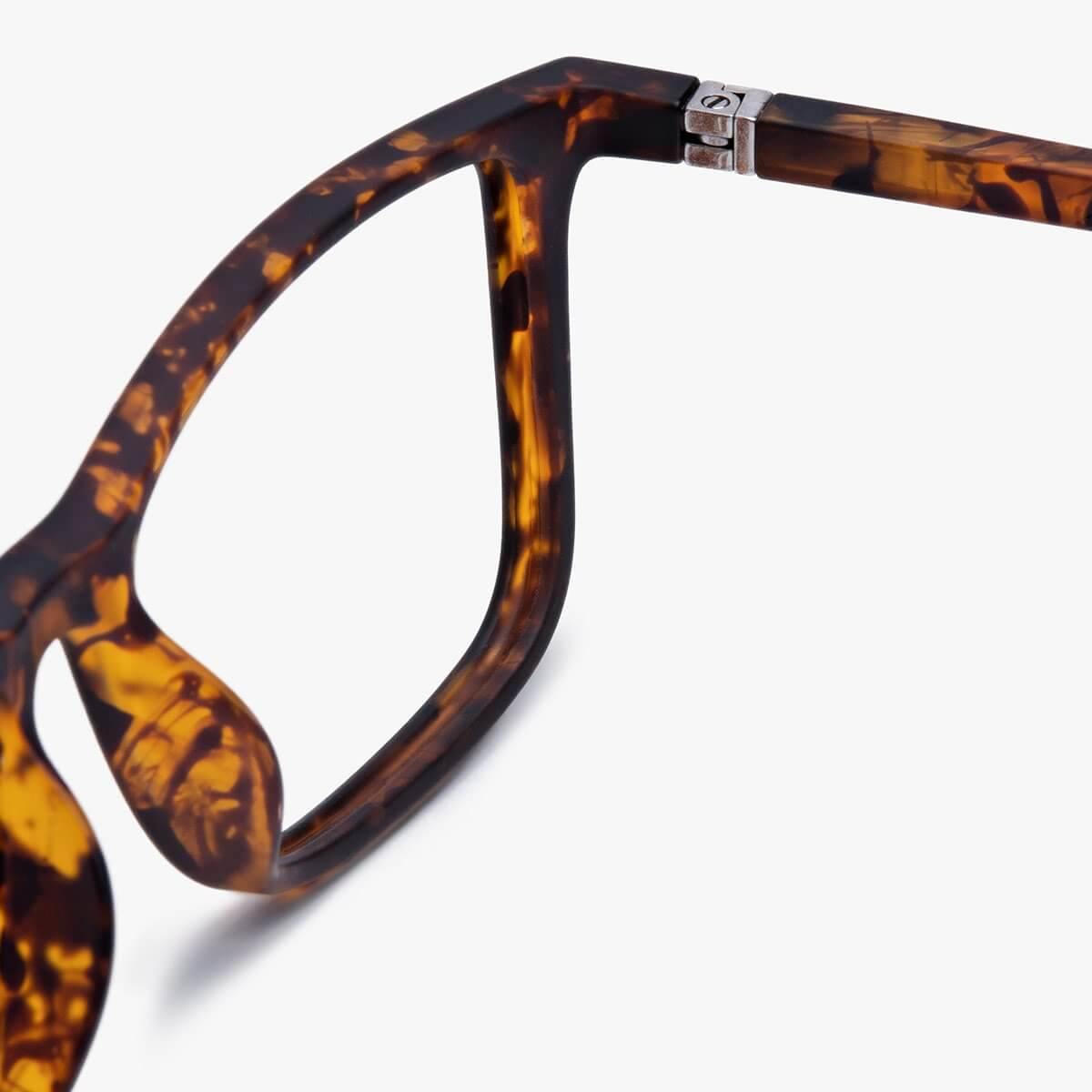 Tortoise-shell patterned eyeglasses frame with metal hinge detail